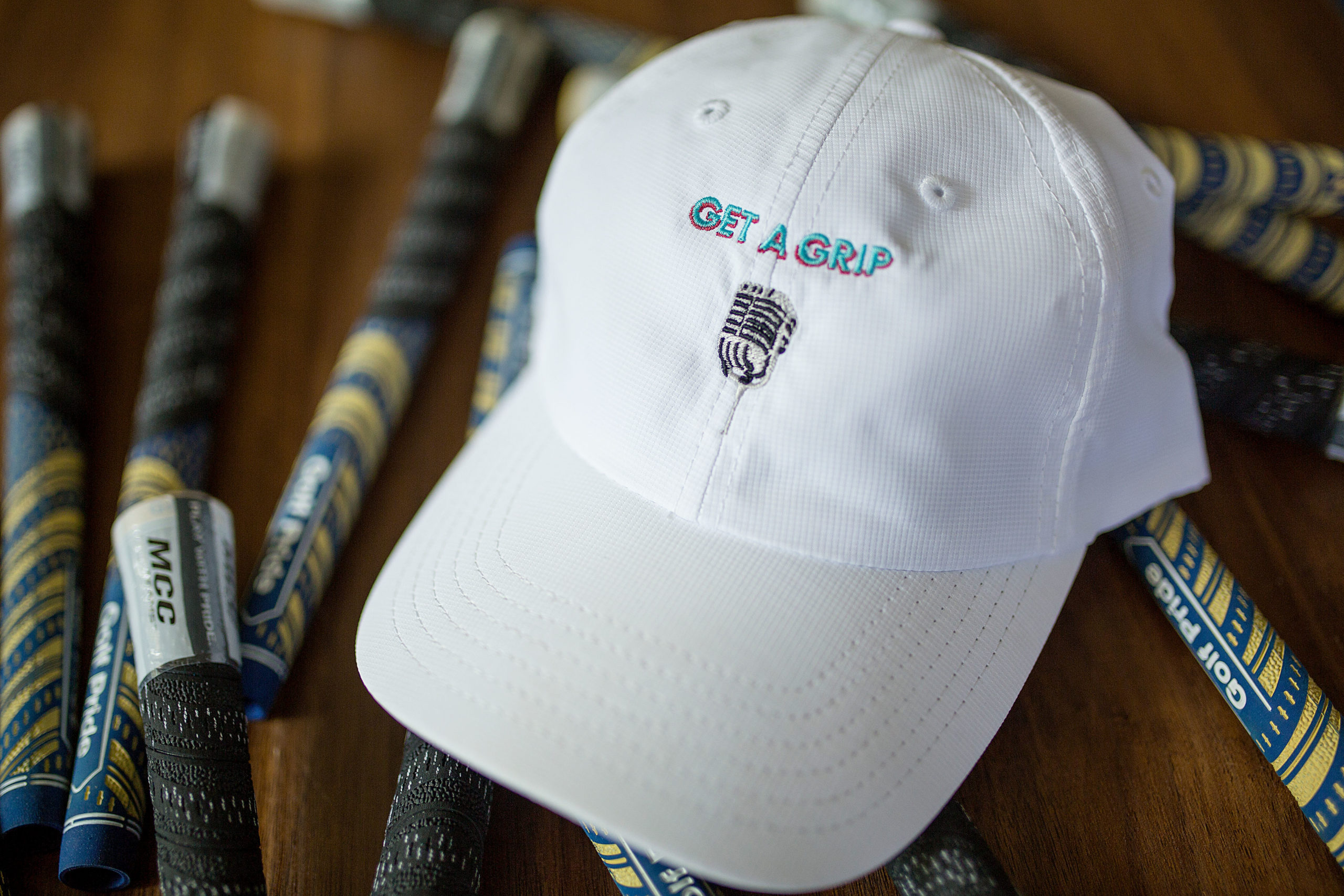 white performance cap with get a grip microphone logo embroider